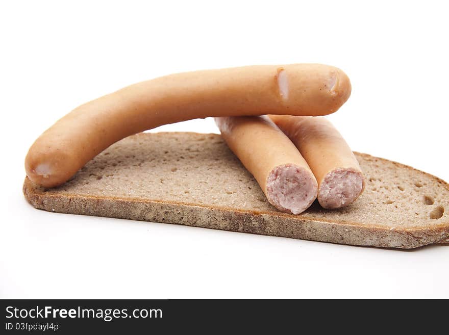 Meat sausage with bread onto white background