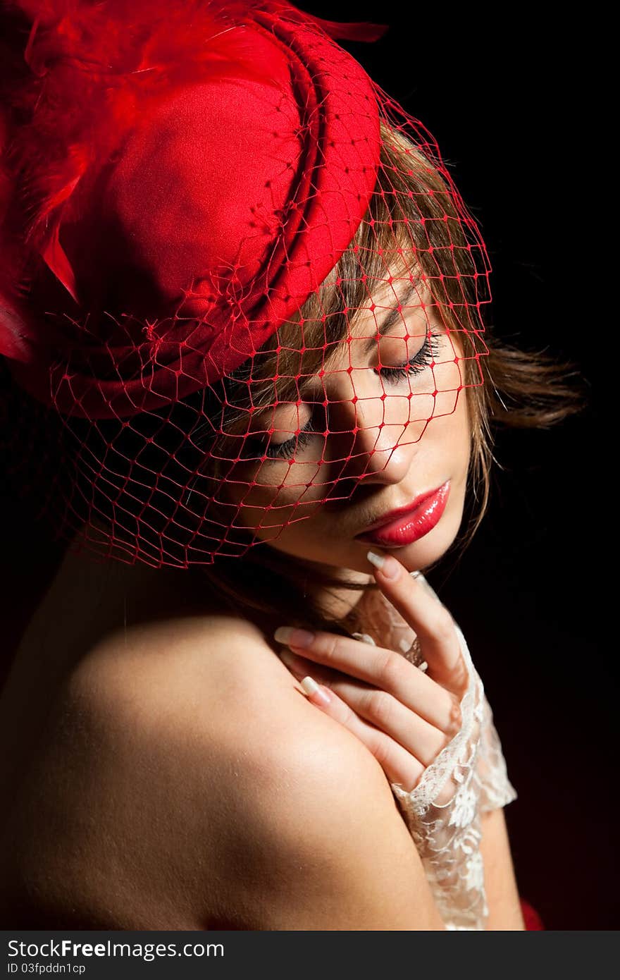 Woman in red hat with net veil