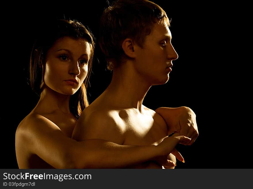 Profile of young Couple Dramatic image shot in studio, on dark. Profile of young Couple Dramatic image shot in studio, on dark