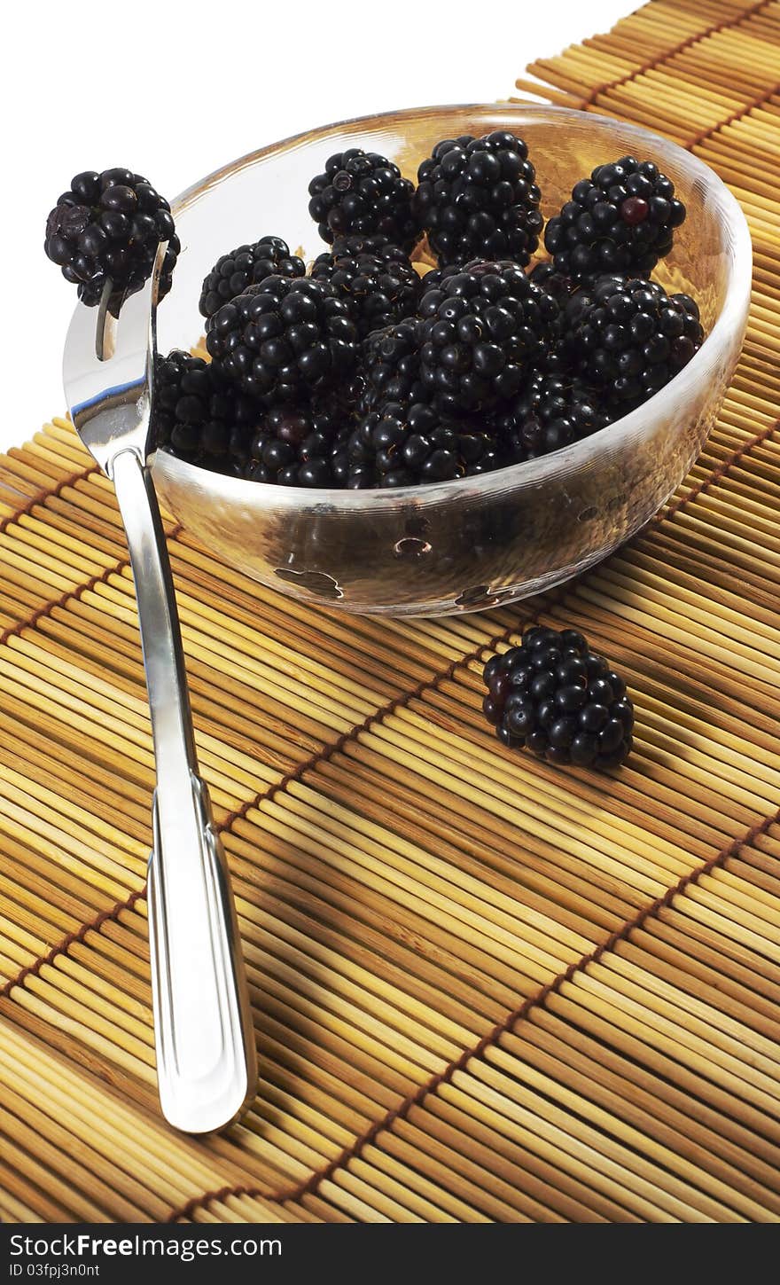 Blackberry in dish with the fork isolated on white. Blackberry in dish with the fork isolated on white