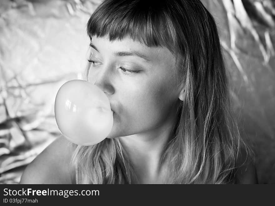 Girl making a bubble from chewing gum b&w