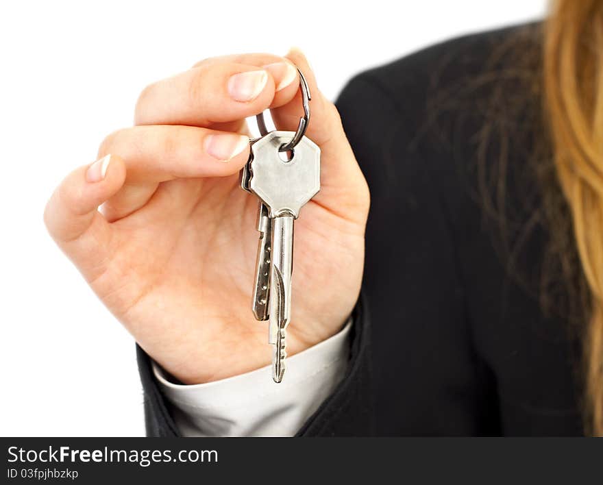 Two silver keys in woman hands in suit