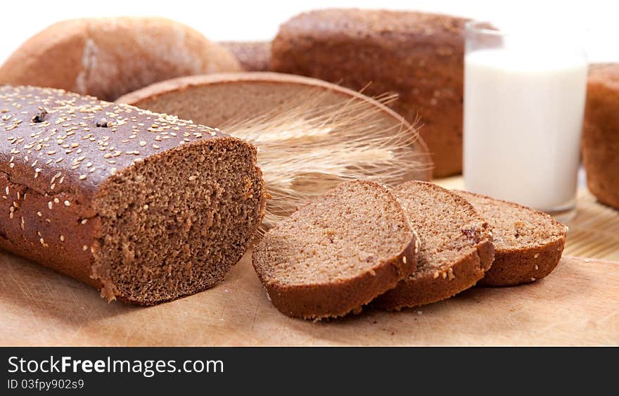 Fresh brown bread with a glass of milk