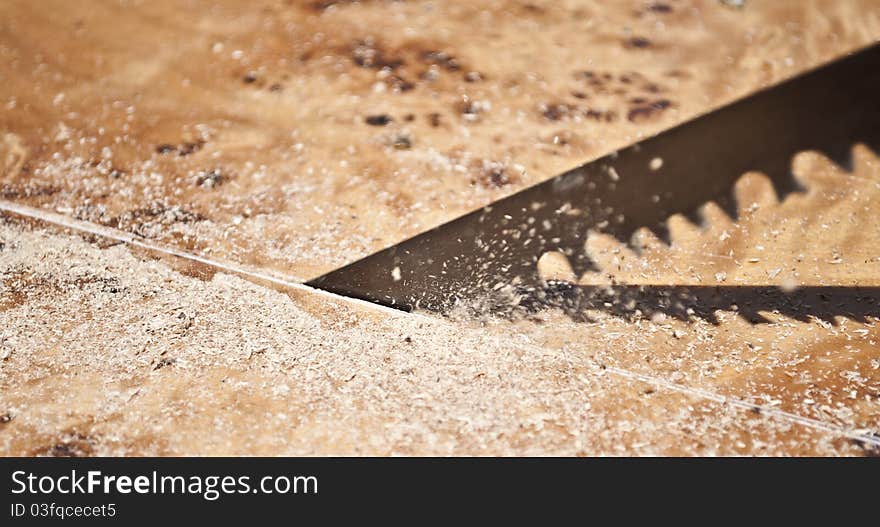 Close-up of a saw cutting wood furniture