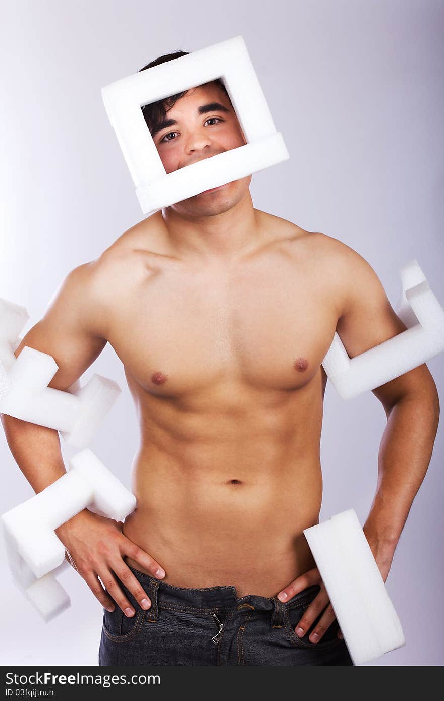 guy is posing with white things. guy is posing with white things