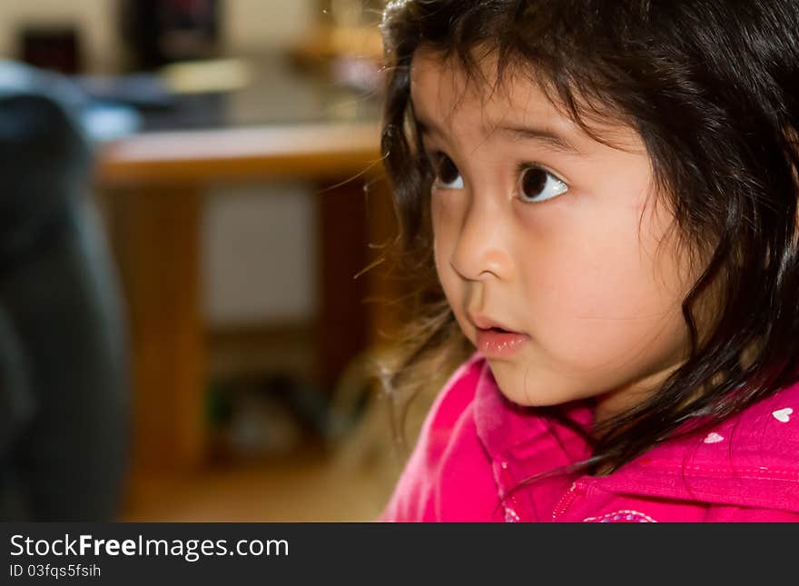 Innocence shows in this young Asian girl's face as she looks up at her mom. Innocence shows in this young Asian girl's face as she looks up at her mom.