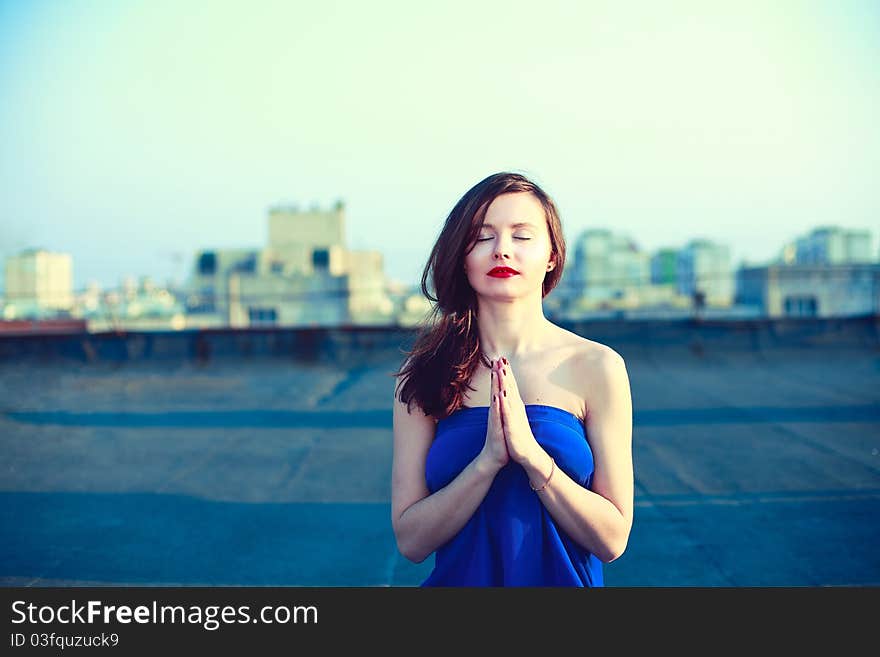 Beautiful girl meditating.Lady in blue