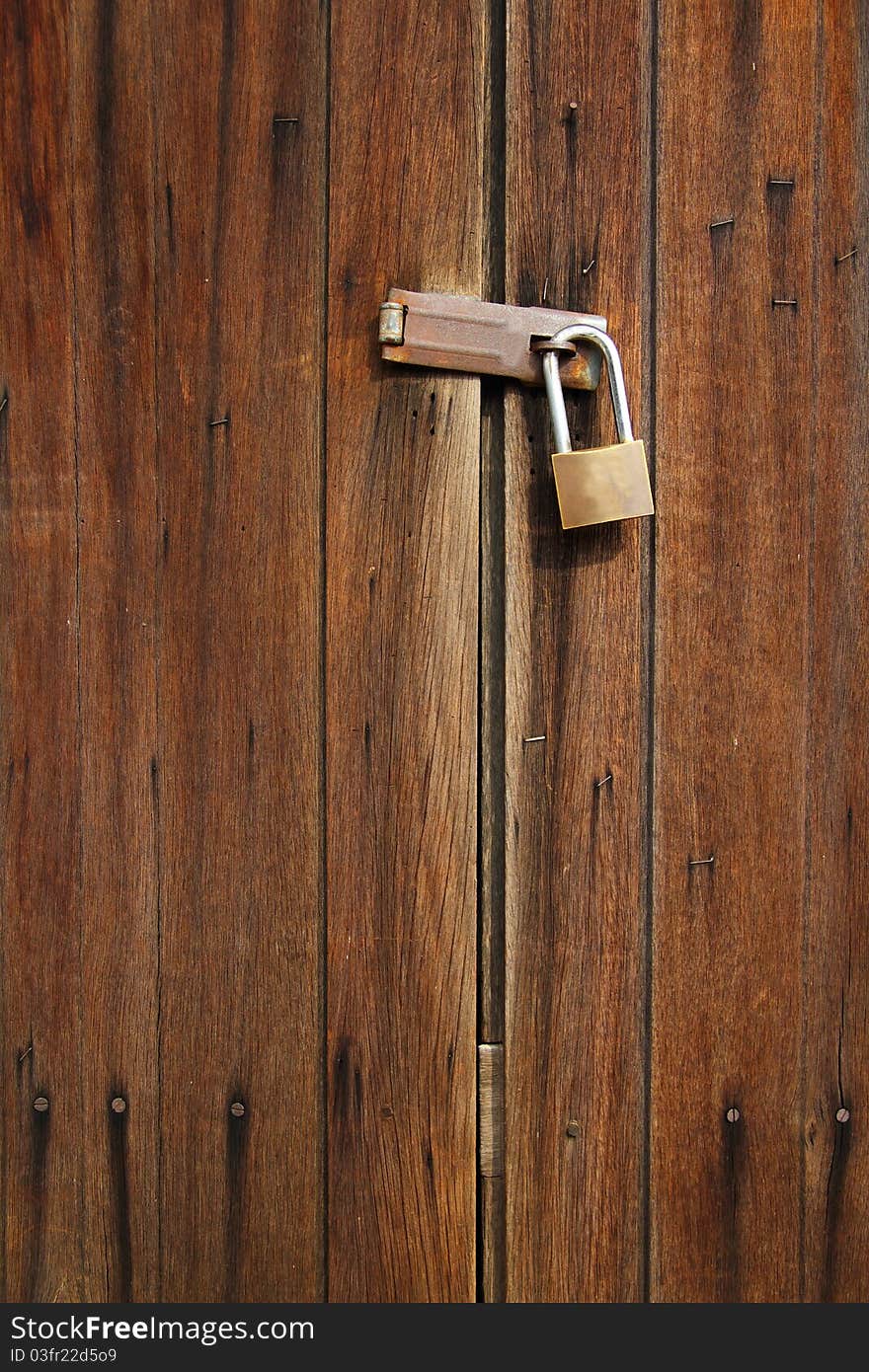 Brown wooden door with lock. Brown wooden door with lock