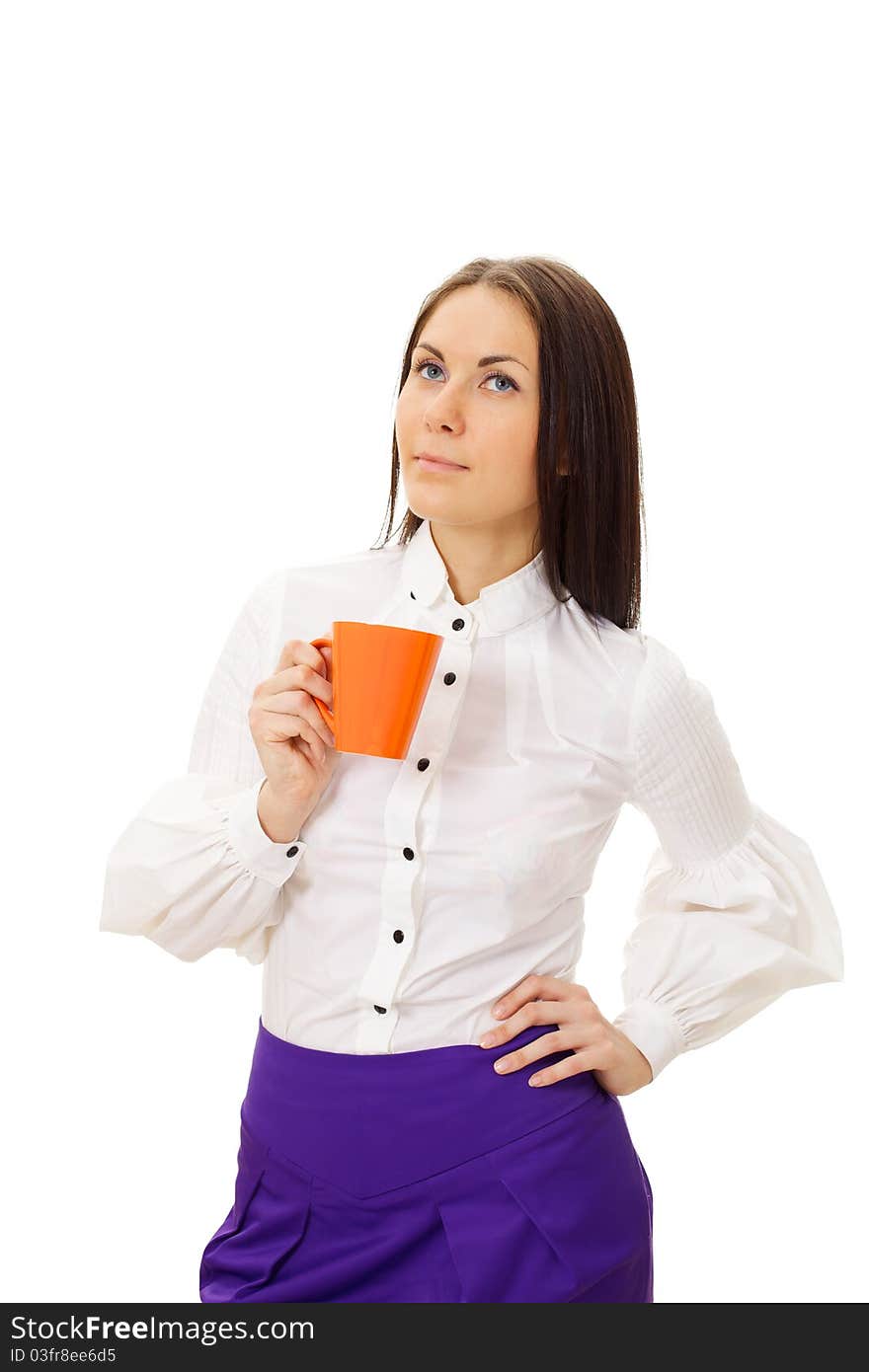 Dreamy beautiful girl in white blouse and violet skirt standing and holding orange cup. Dreamy beautiful girl in white blouse and violet skirt standing and holding orange cup.