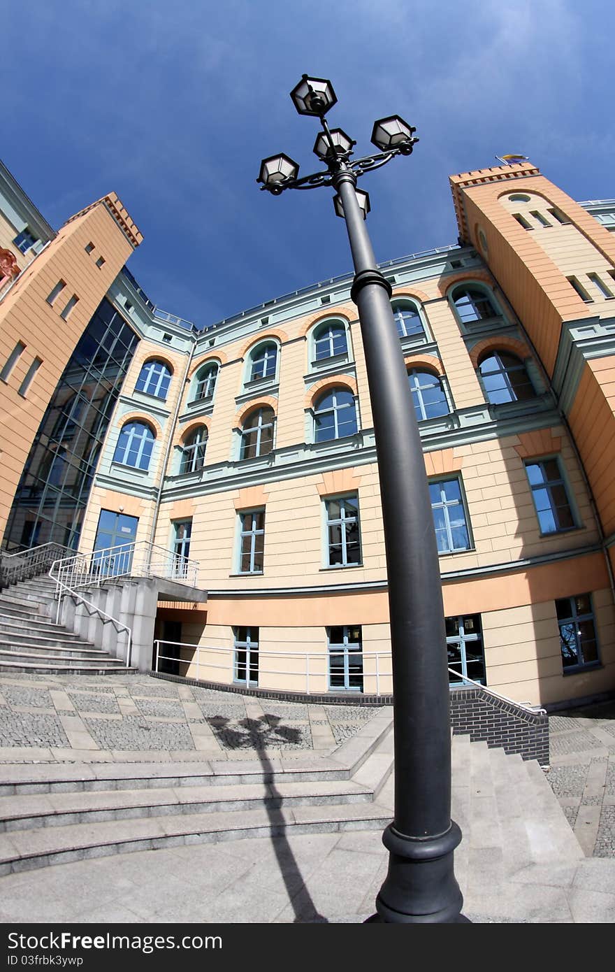 Facade of the building in pastel colors and a stylish lantern