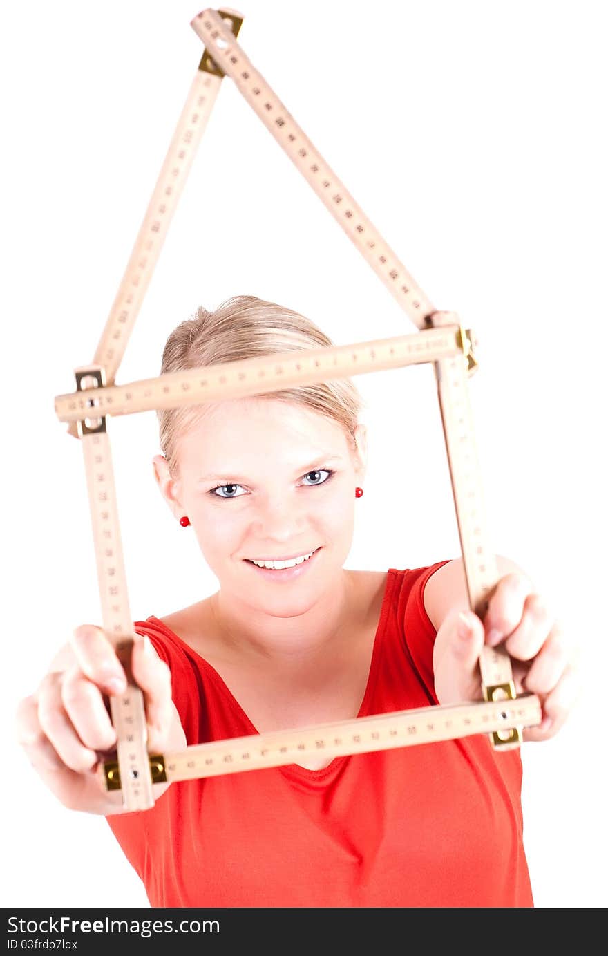 Young woman with folding rule as a house symbol. Young woman with folding rule as a house symbol