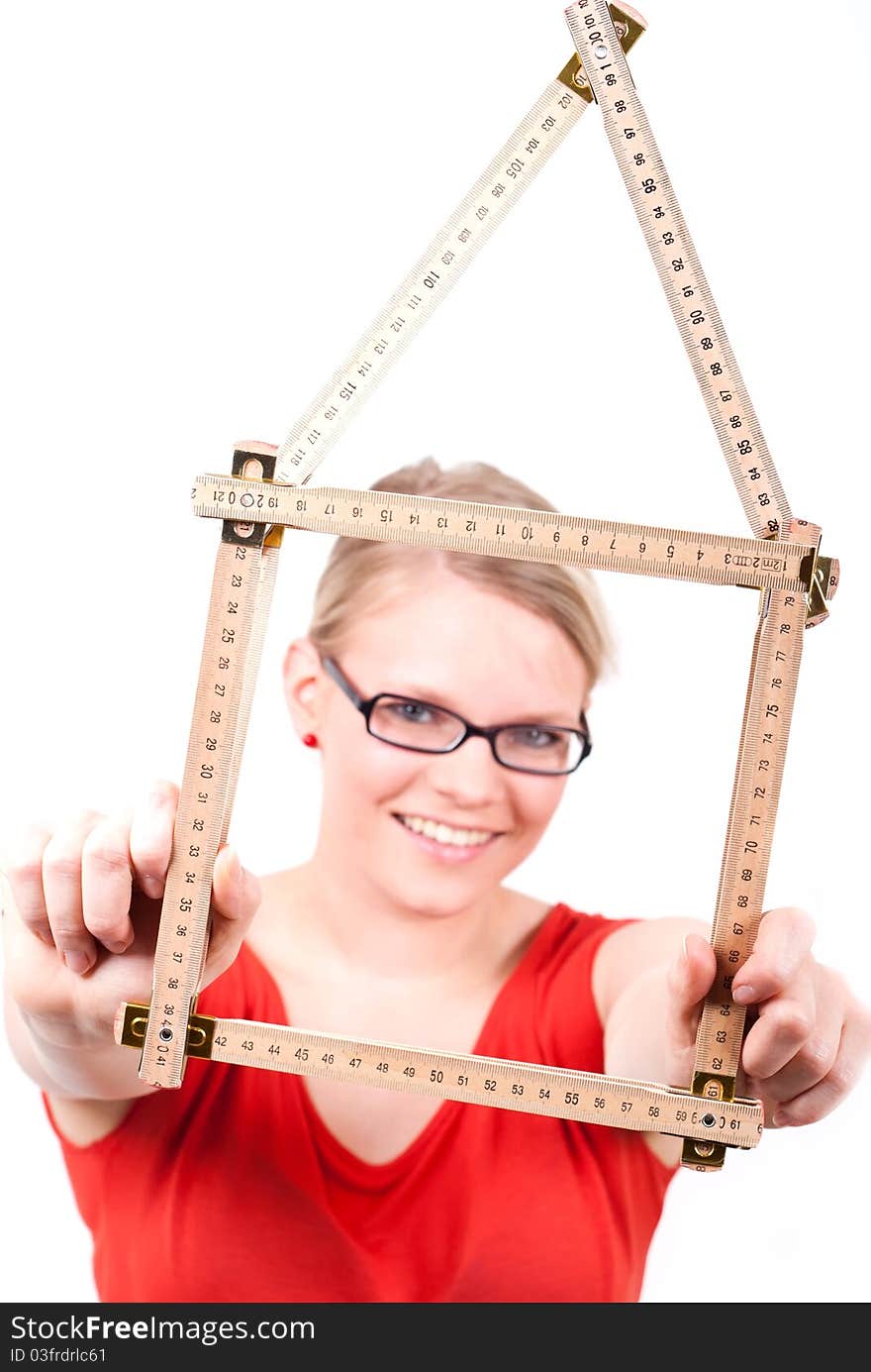 Young woman with folding rule as a house symbol. Young woman with folding rule as a house symbol