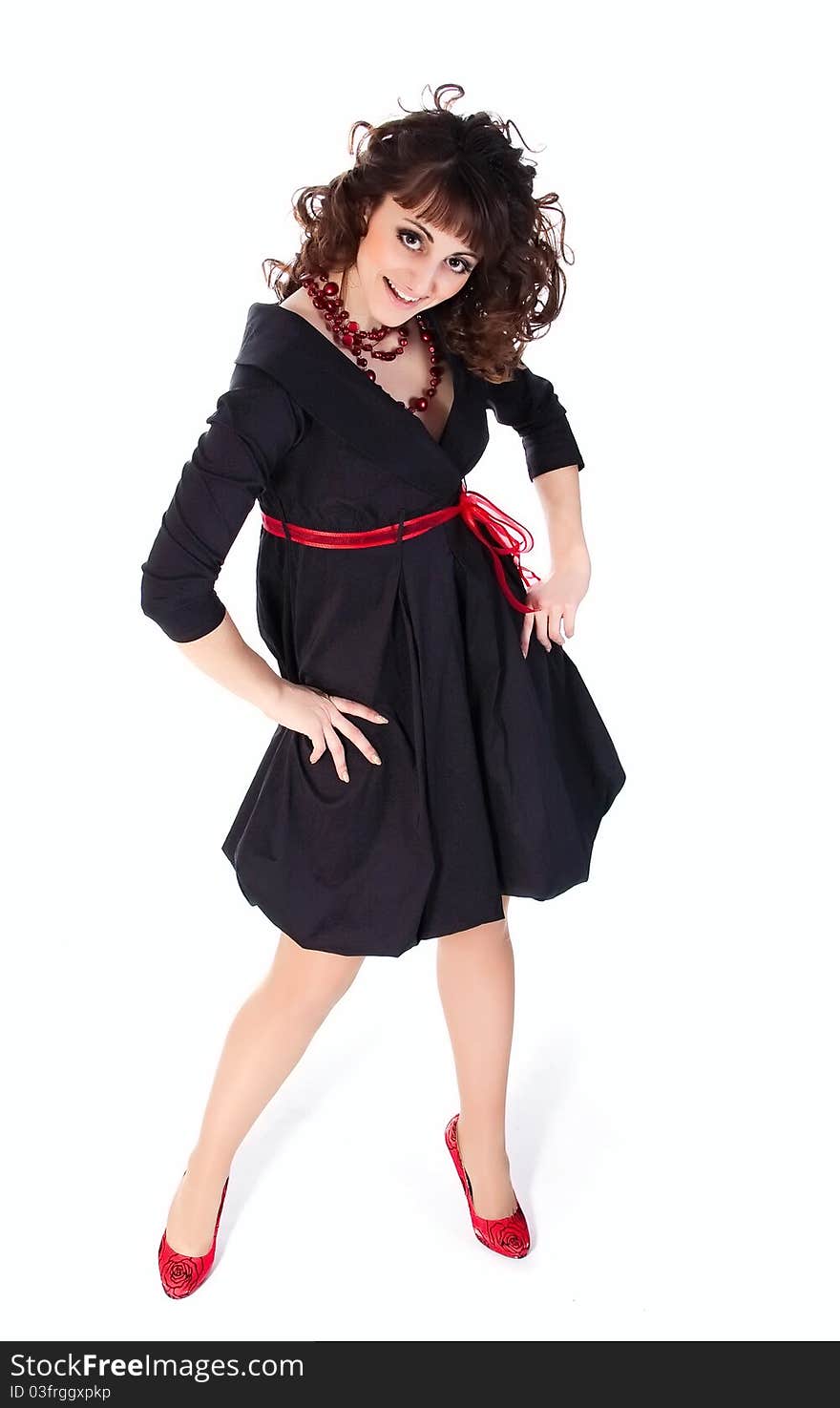 Young brunette in black dress on a white background