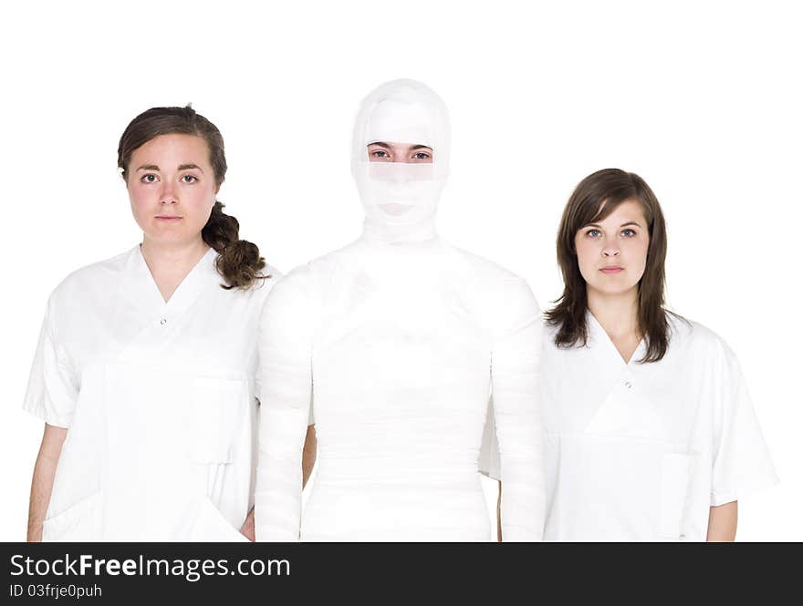 Mummified person with two female nurses. Mummified person with two female nurses