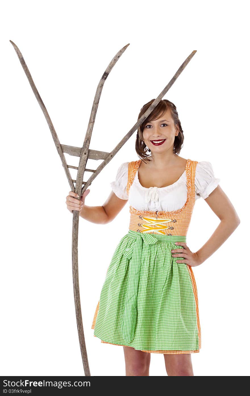 Beautiful woman with dirndl holds pitchfork