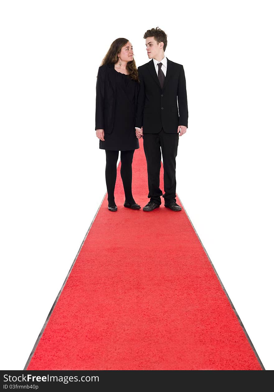 Couple standing on a red carpet isolated on white background