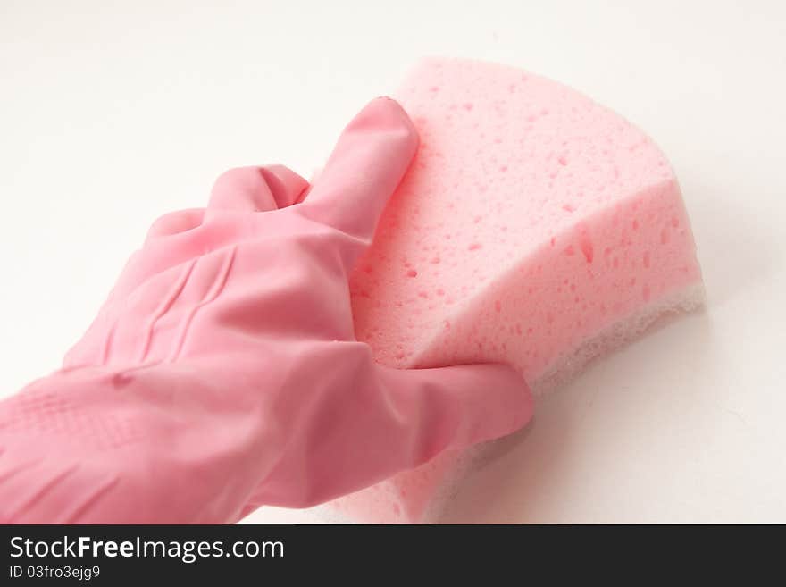 Hand in a pink rubber glove holding a pink sponge. Hand in a pink rubber glove holding a pink sponge