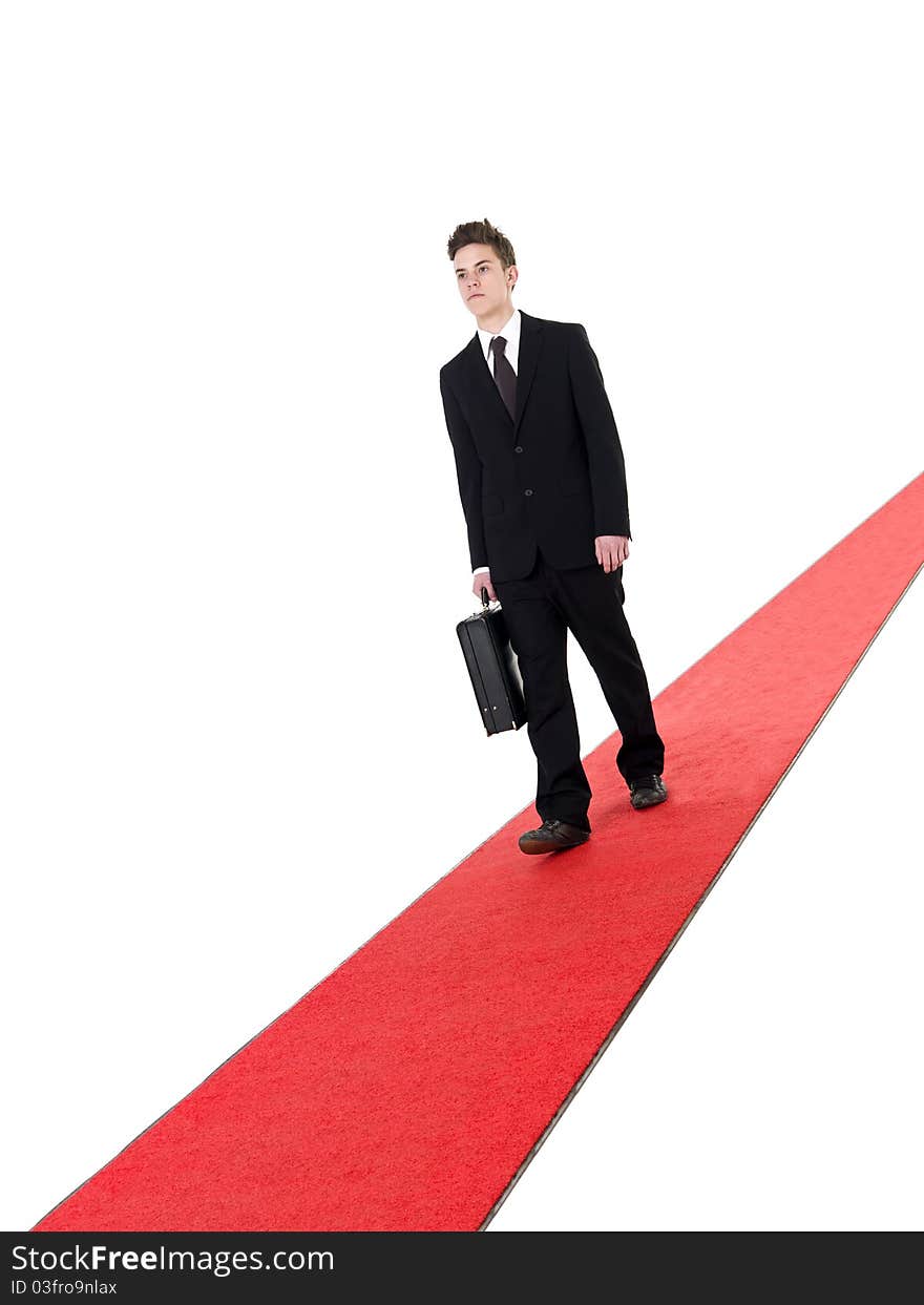 Businessman on a red carpet isolated on white background