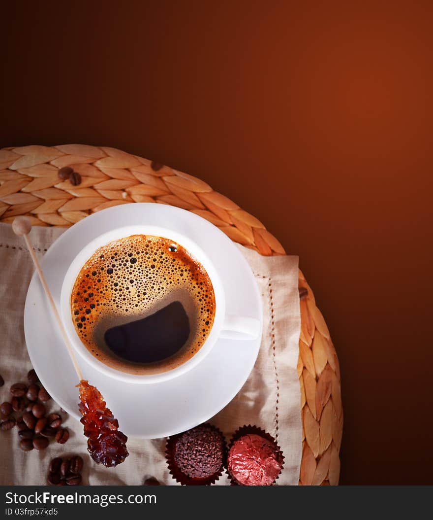 Coffee cup with sugar stick and beans on dark background. Coffee cup with sugar stick and beans on dark background