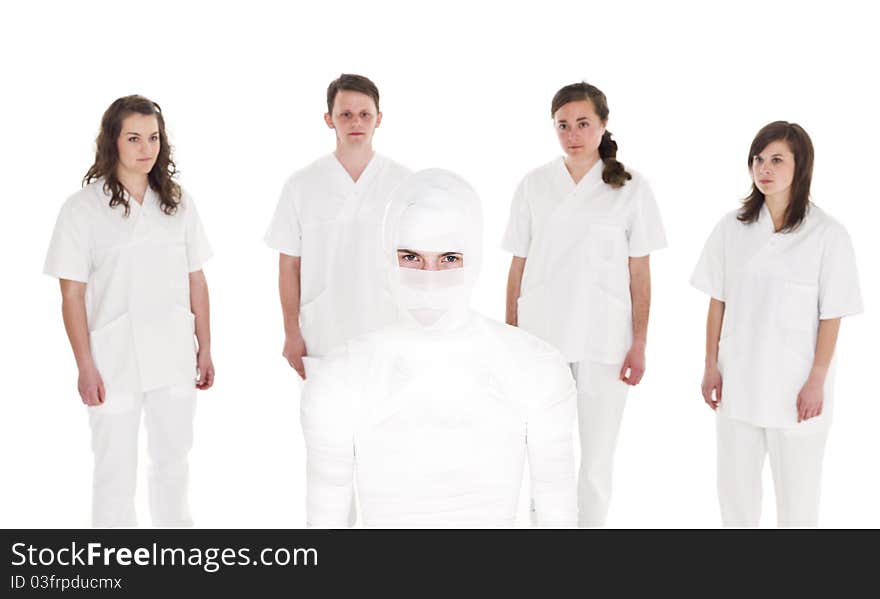 Mummyfied Patient in front of Healtcare Staff isolated on white background