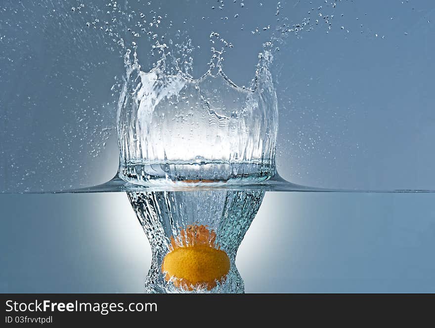 Fresh tangerine dropped into water. Fresh tangerine dropped into water