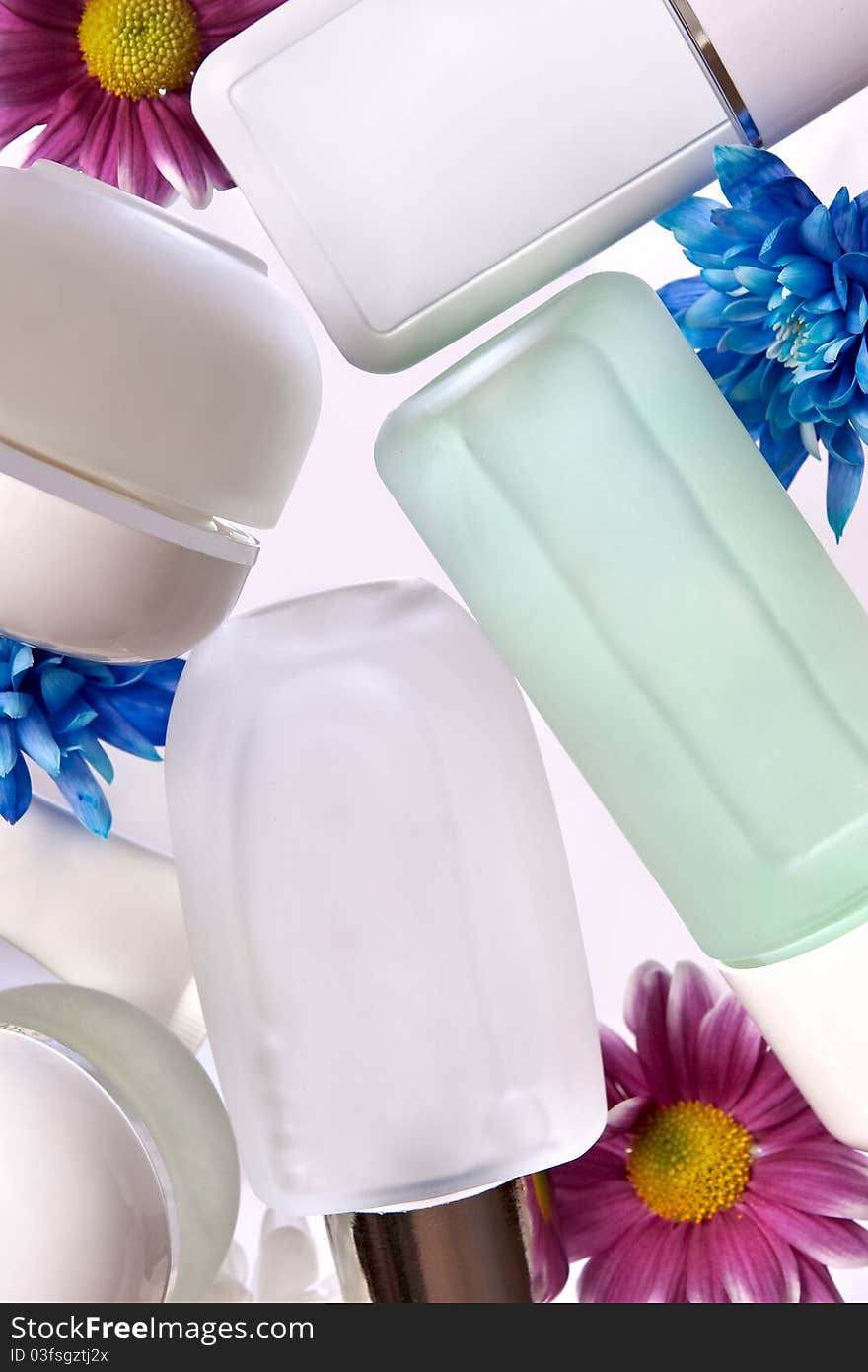 Bottles and flowers on a white background