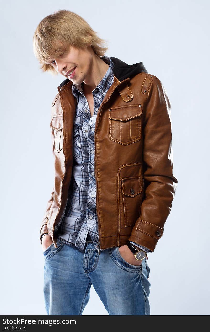 Handsome young man in leather jacket, studio portrait