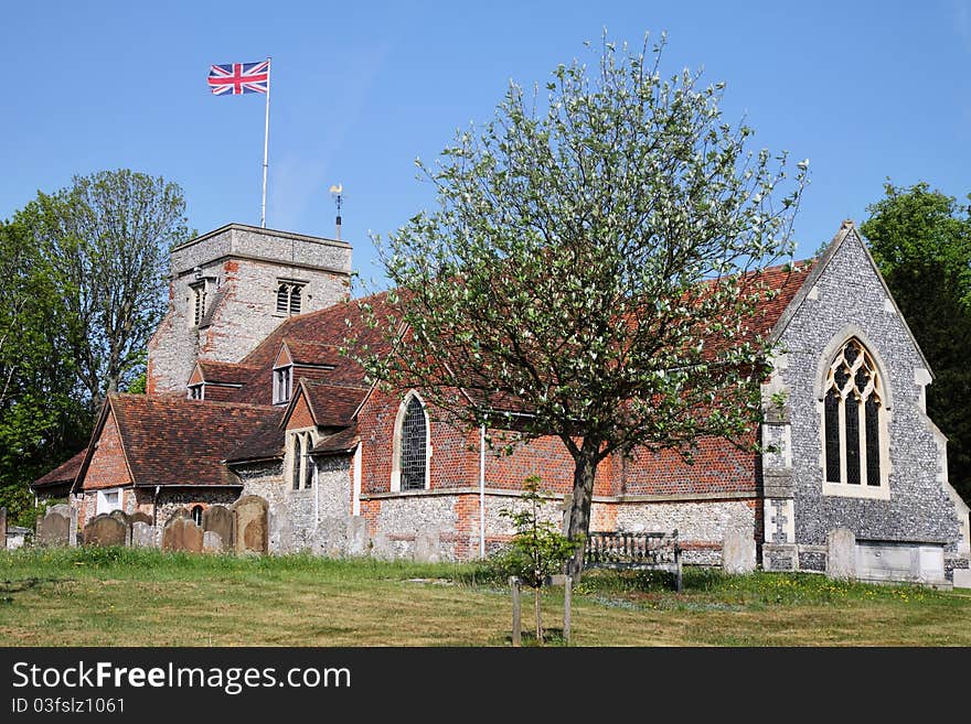 English Village Church and Tower with Union Jack Flag flying. English Village Church and Tower with Union Jack Flag flying