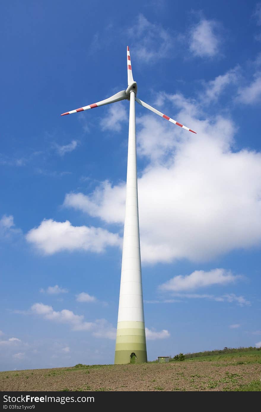 Single wind turbine tower. Sky with clouds. Single wind turbine tower. Sky with clouds.