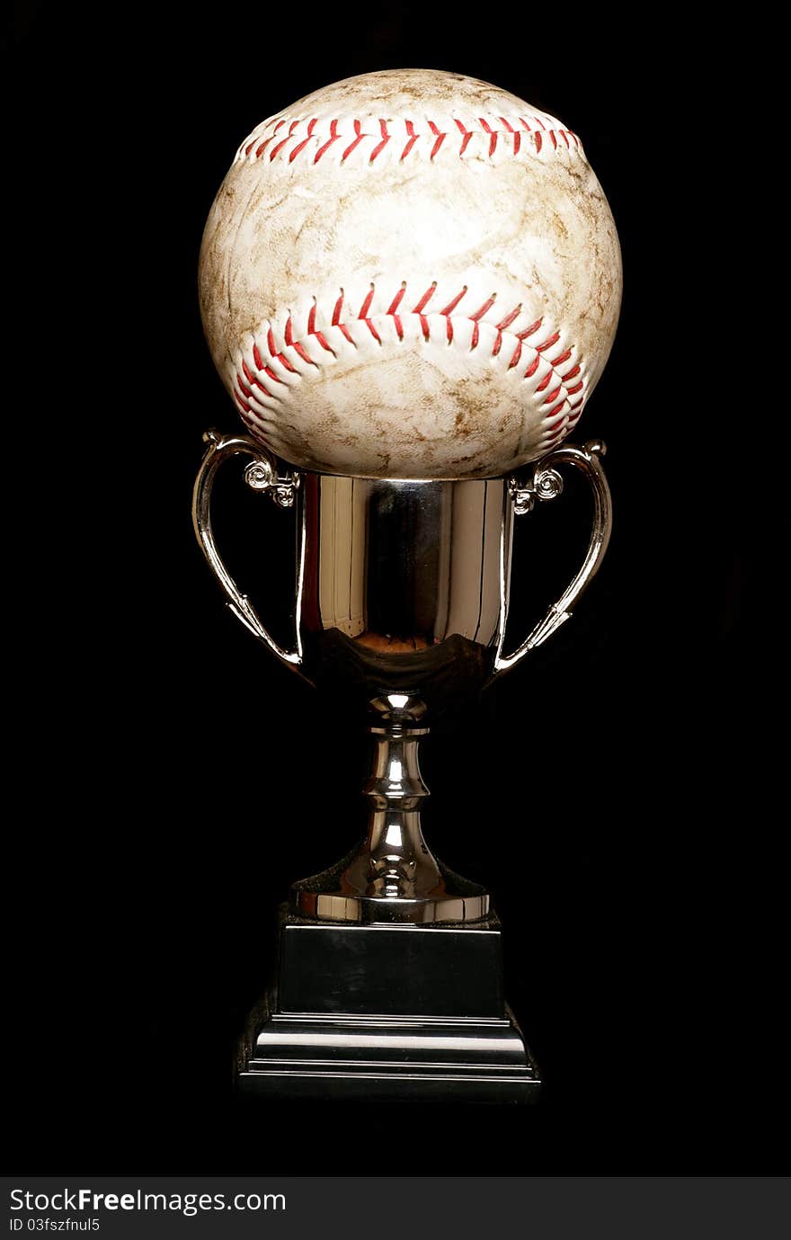 Trophy and softball isolated on black