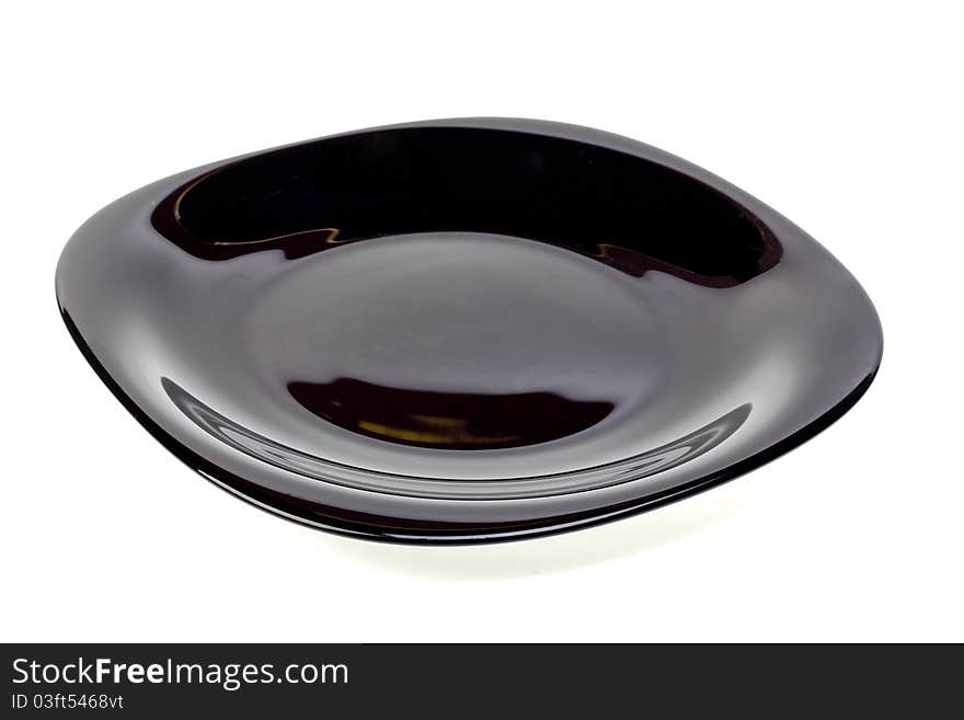 Plate from dark glass on a white background