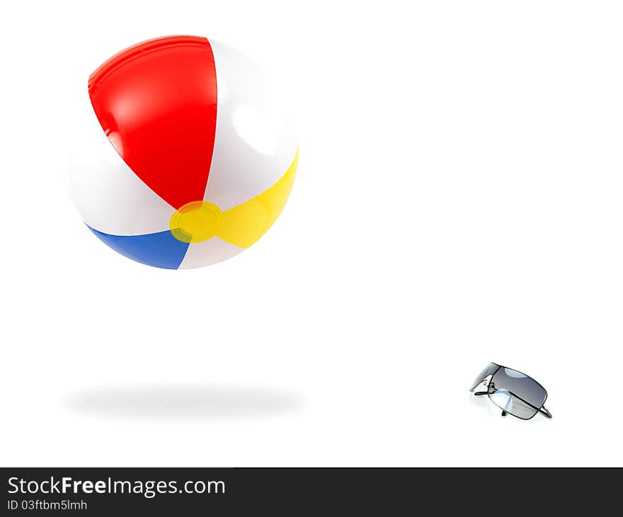 Sunglasses and a beach ball against a white background. Sunglasses and a beach ball against a white background