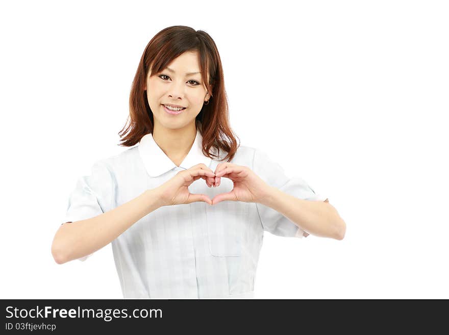 Young japanese nurse shows fingers heart symbol. Young japanese nurse shows fingers heart symbol