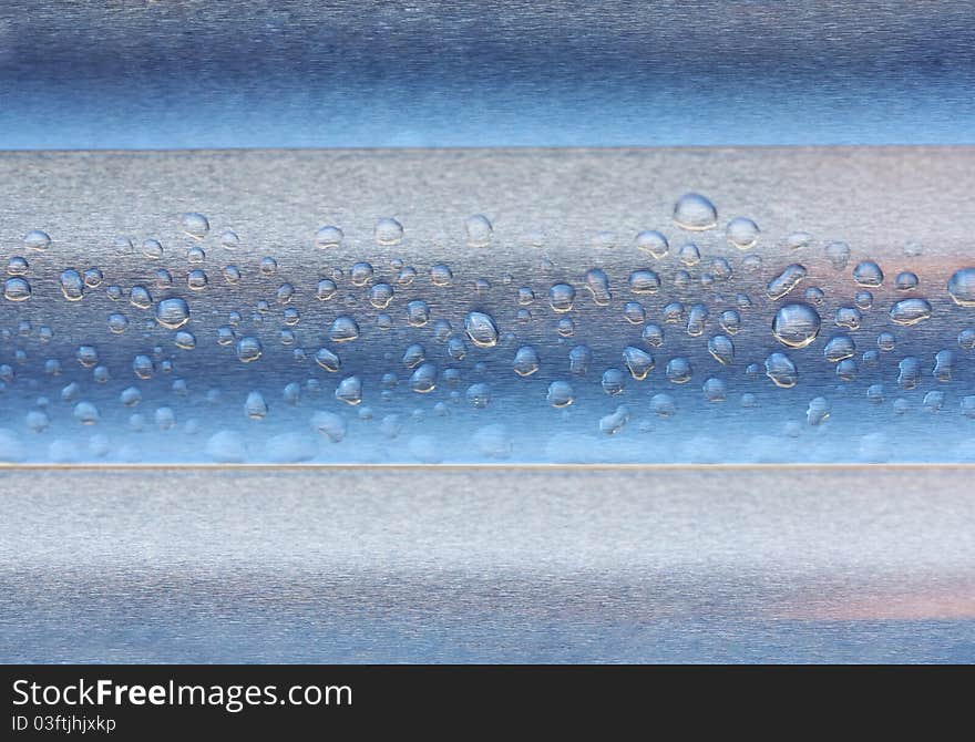 Abstract composition of waterdrops over metal surface, copy space