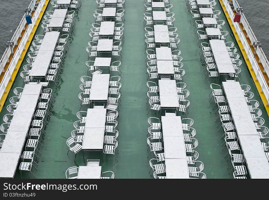 Dining aboard. a boat along a long dining table on a boat on a river.