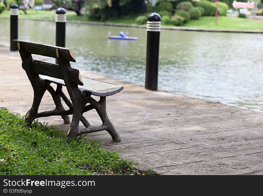 Chairs in the park. out the other one is located in a park pool.