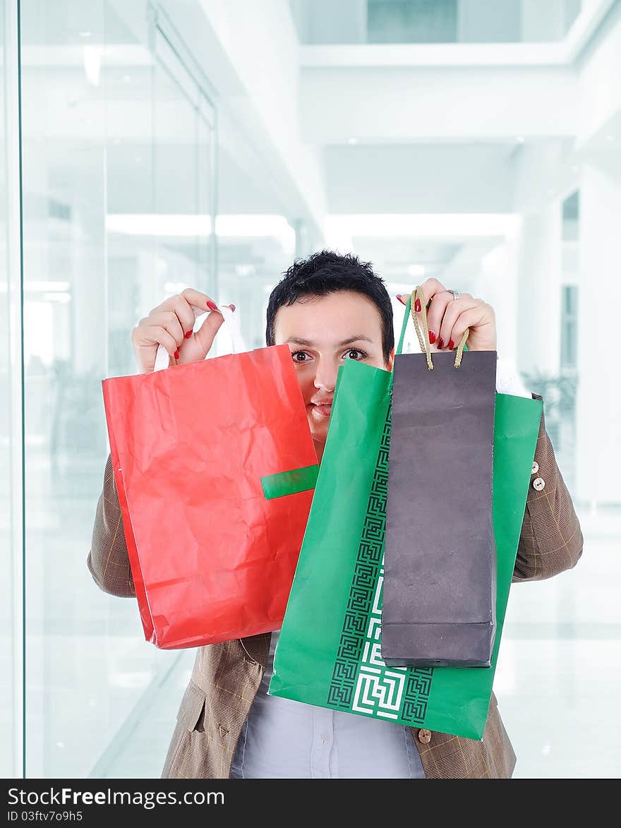 Modern woman shopping in mall holding bags