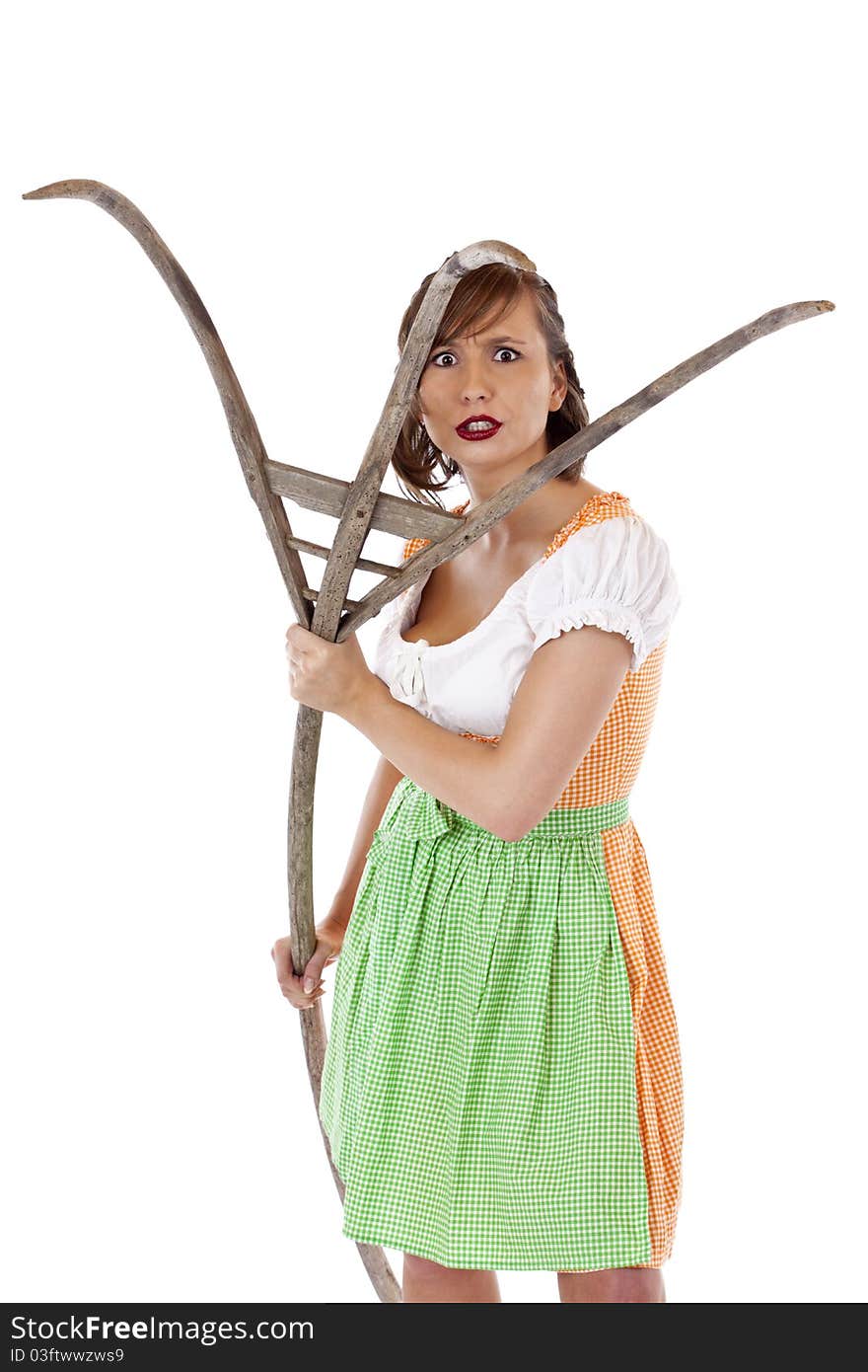 Beautiful young Bavarian woman with dirndl attacks with pitchfork.Isolated on white background. Beautiful young Bavarian woman with dirndl attacks with pitchfork.Isolated on white background.