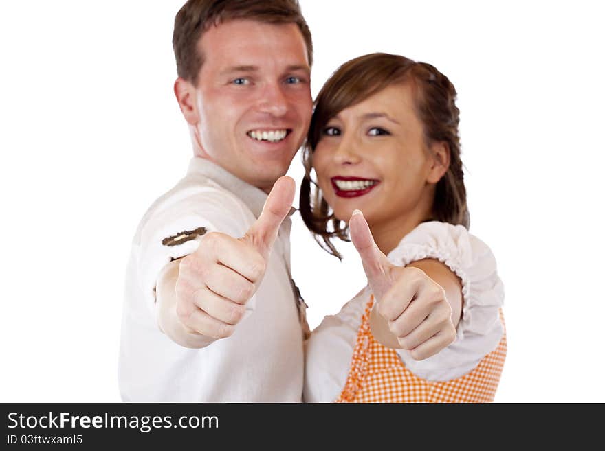 Successful Bavarian man and woman with dirndl hold thumbs up. Isolated on white background. Successful Bavarian man and woman with dirndl hold thumbs up. Isolated on white background.