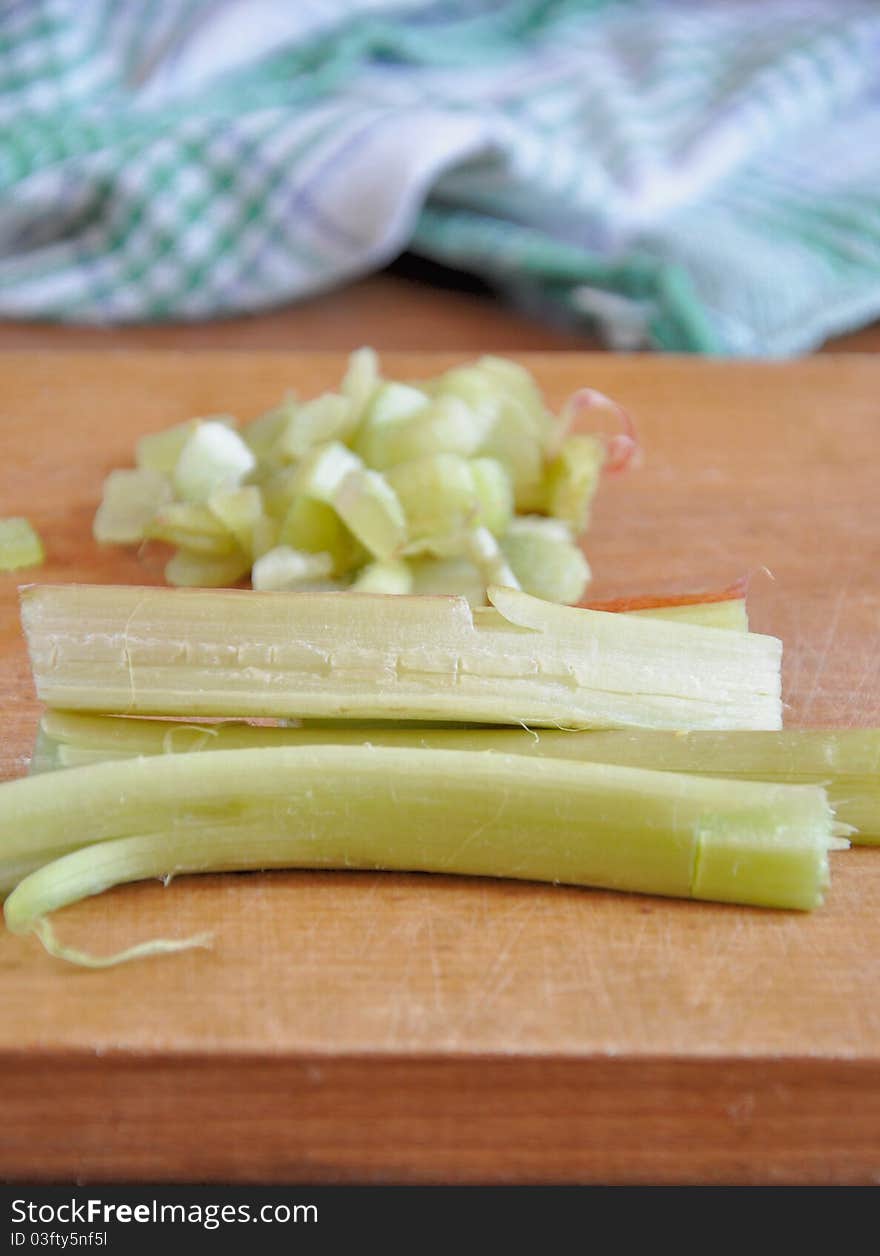 Fresh rhubarb chopped into pieces on a cutting board