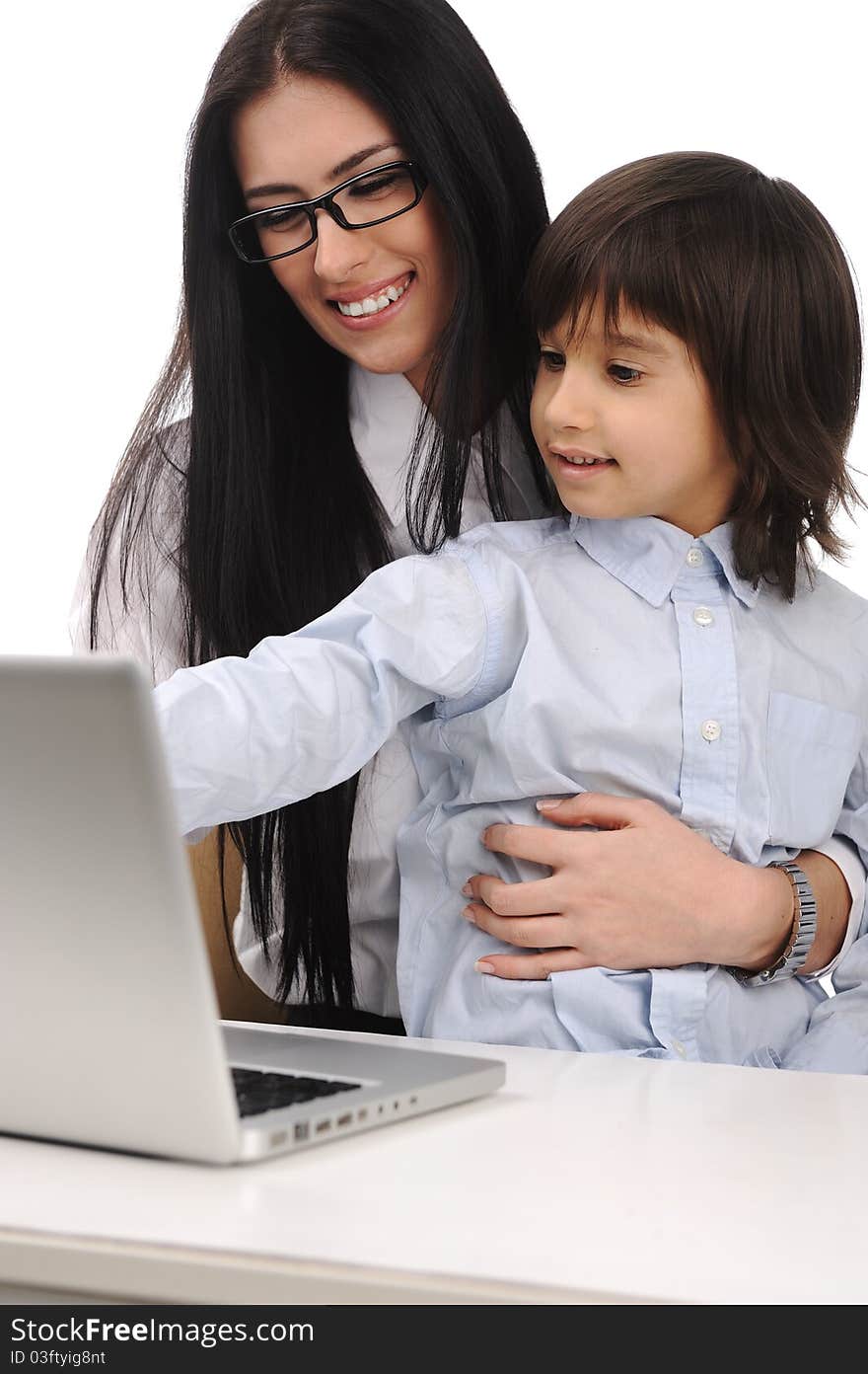 Happy mother and son on laptop at the table