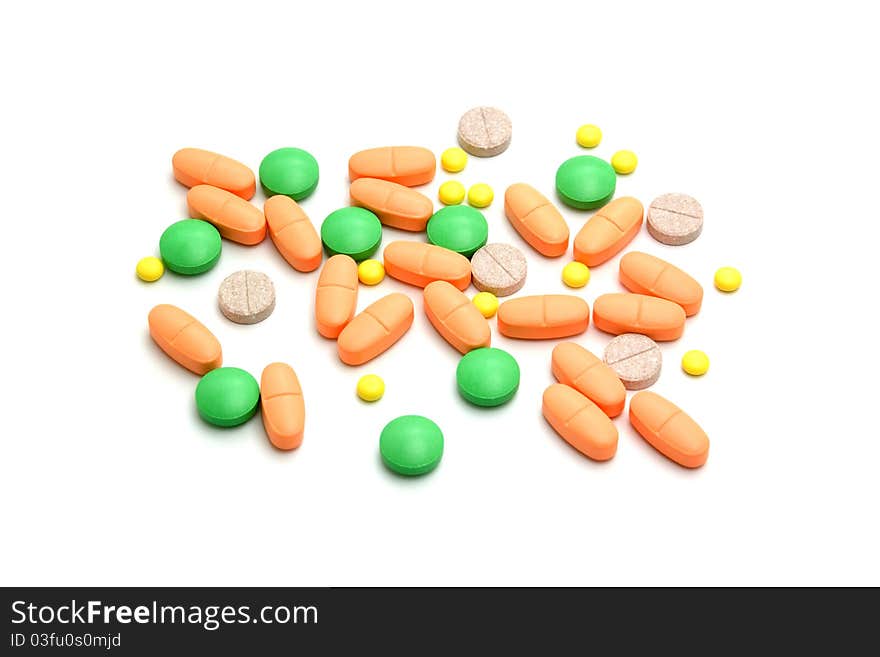 A lot of colourful bright pills on white background. A lot of colourful bright pills on white background