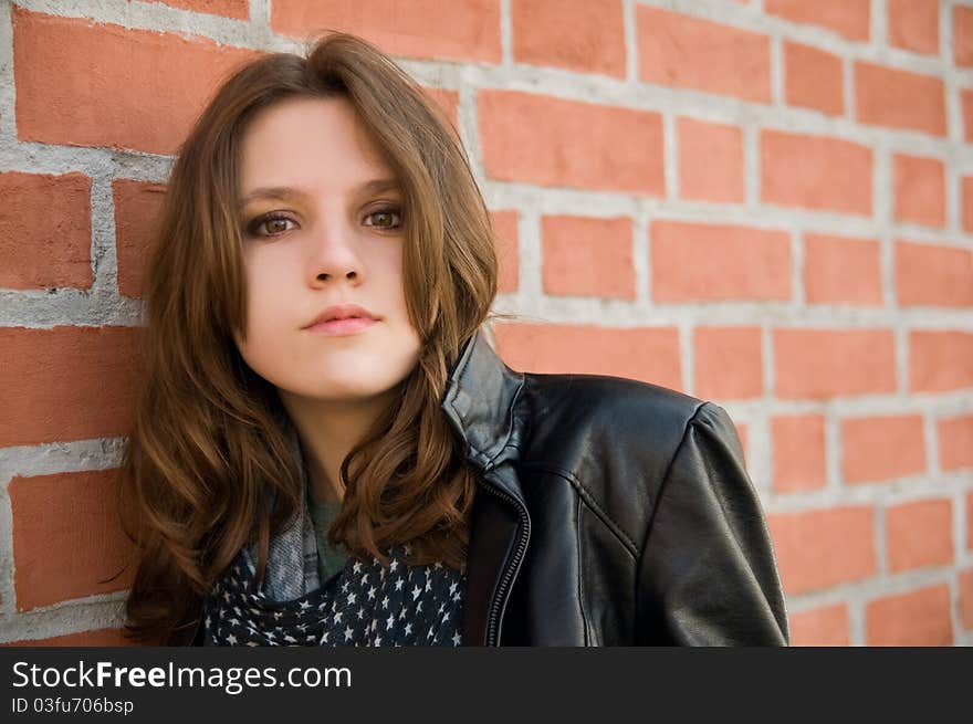 Teenage girl on a brick background