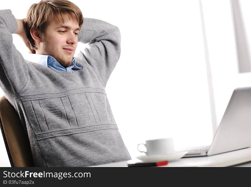 Relaxed young man in office