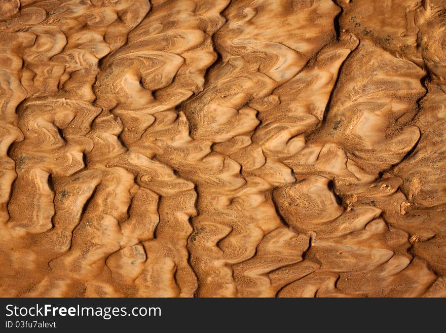 Beautiful rippled wet sand background or texture