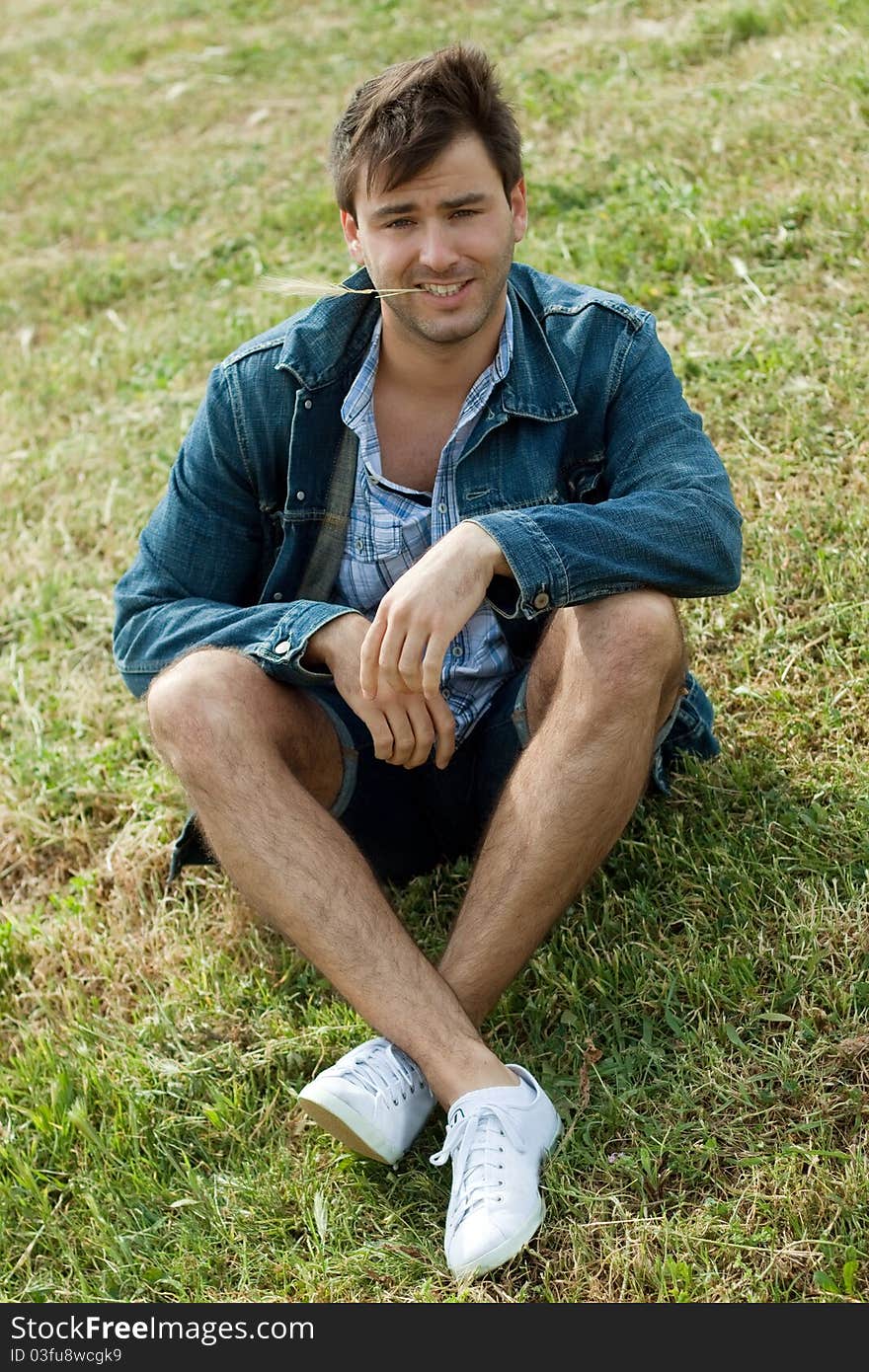 A young man in a park on the grass