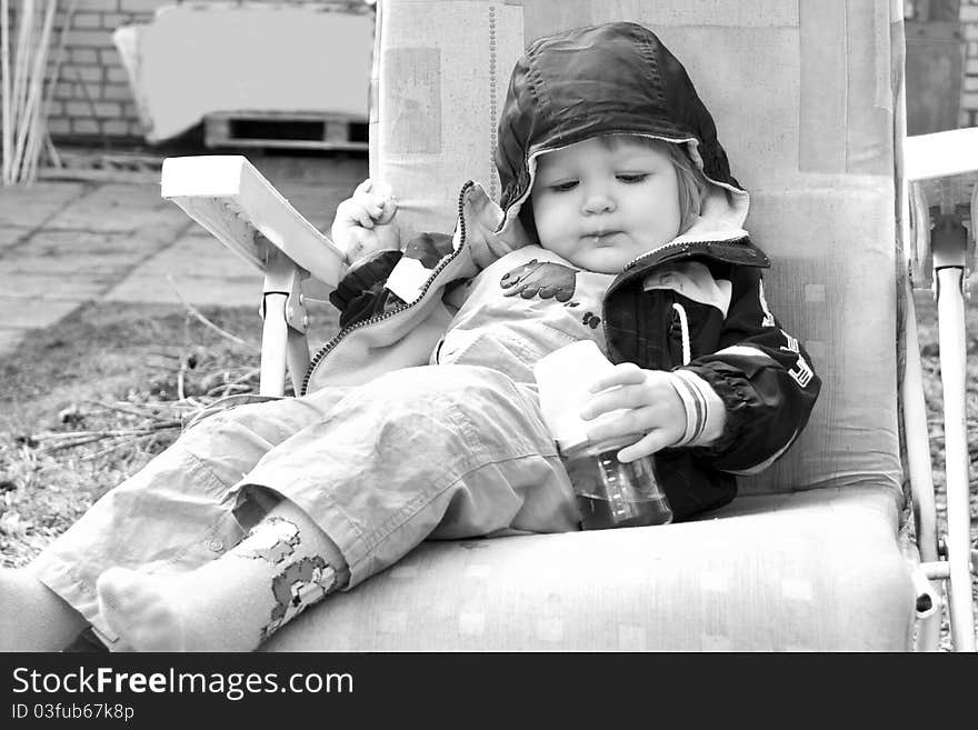 Baby girl eating outdoors. Black and White image of baby. Baby girl eating outdoors. Black and White image of baby.