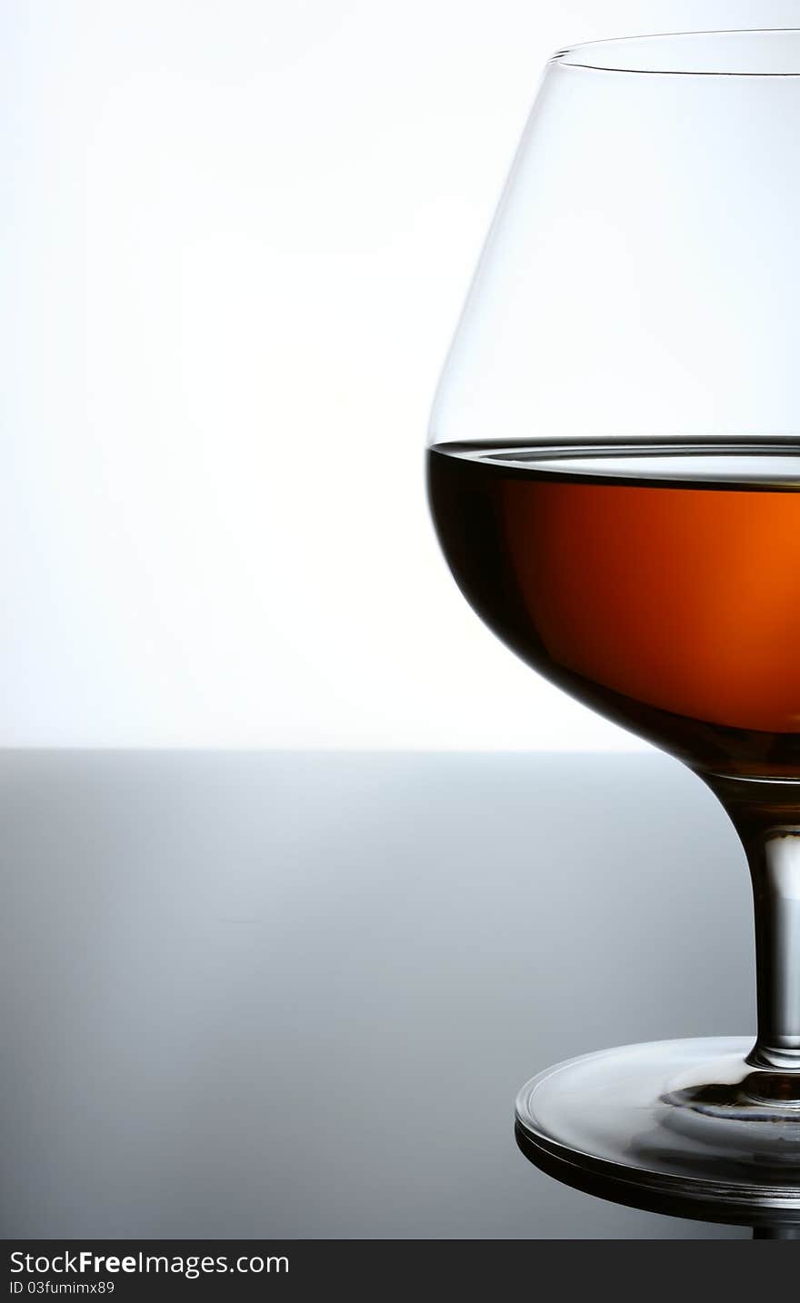 Cognac, whisky, rum, wine glass. Blue toned background