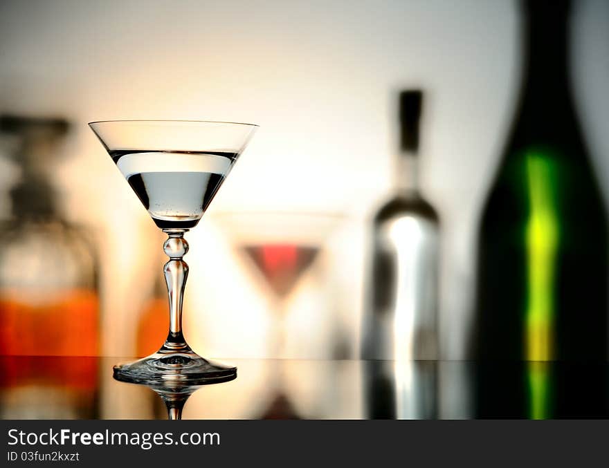 Glass on a background with the shadows of bottles. Glass on a background with the shadows of bottles