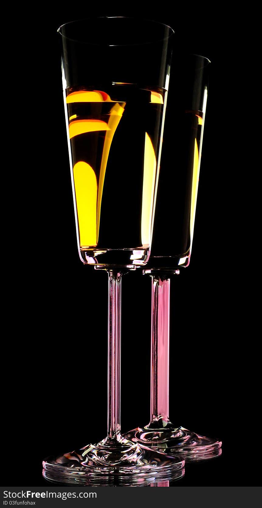 Two glass of white wine on black background. Low key style.